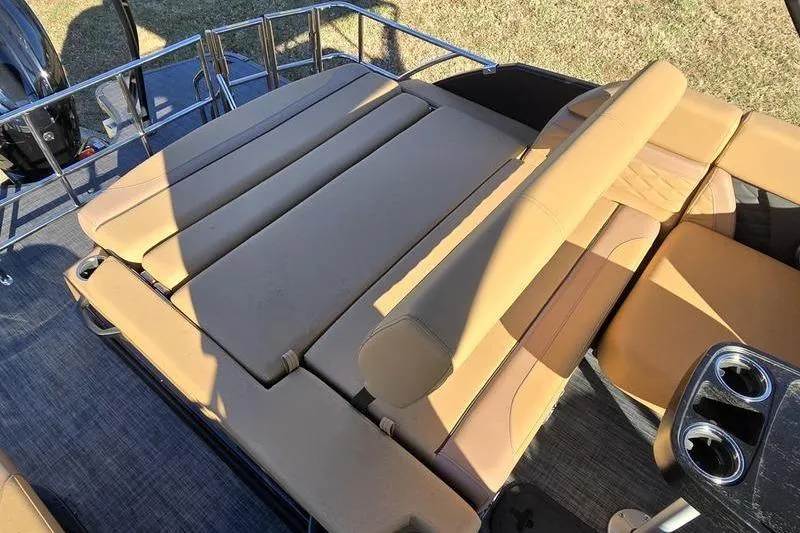 Slide: The Image of 2026 Godfrey Monaco 235 SFL boat with tan seating and cup holders. - 15