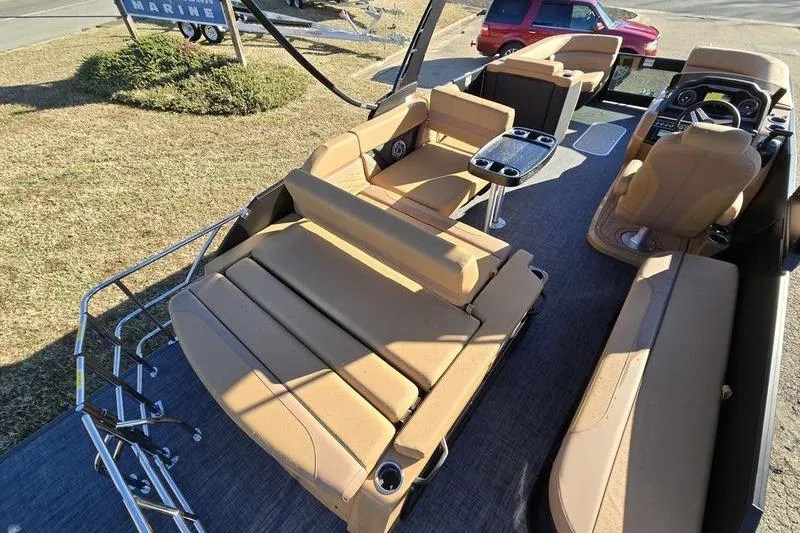 Slide: The Image of 2026 Godfrey Monaco 235 SFL pontoon boat with tan seating and modern interior design. - 17