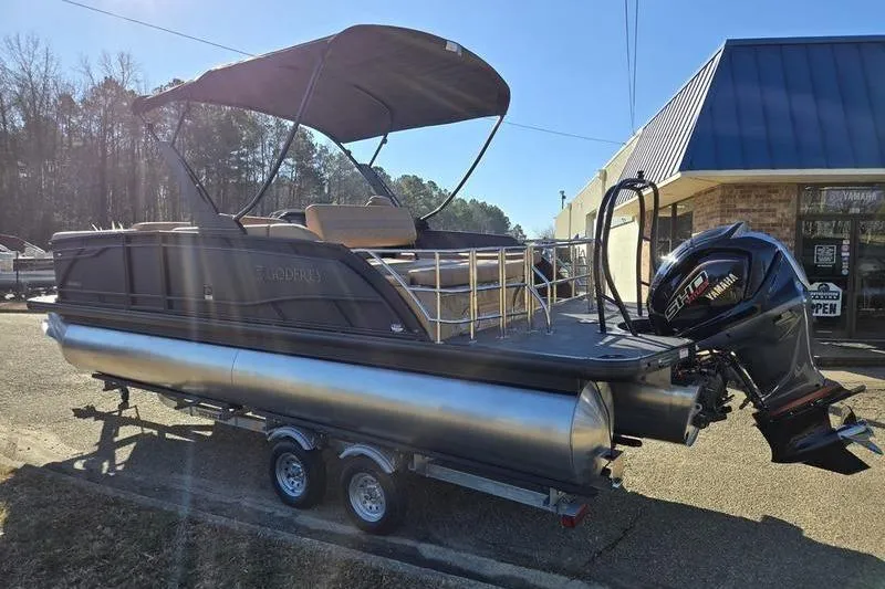 Slide: The Image of 2026 Godfrey Monaco 235 SFL pontoon boat on trailer, featuring Yamaha outboard motor. - 2