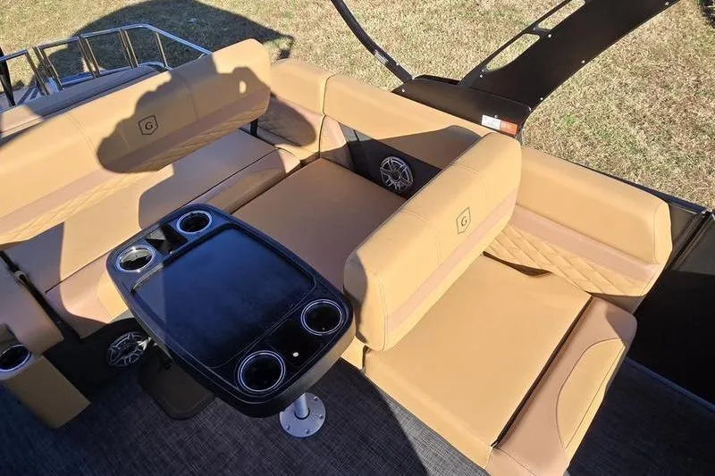 Slide: The Image of Luxurious seating area on 2026 Godfrey Monaco 235 SFL boat with cup holders and table. - 3