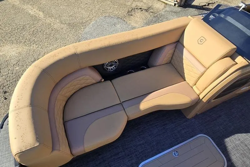 Slide: The Image of Luxurious seating on 2026 Godfrey Monaco 235 SFL pontoon boat, featuring tan upholstery. - 5