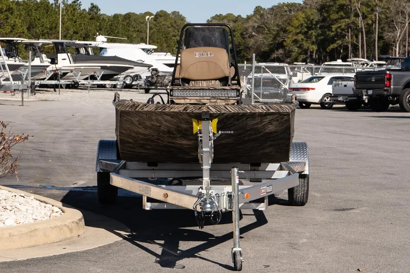 Slide: The Image of 2026 Excel 1860 Shallow Water F4 CC boat on trailer in parking lot. - 3