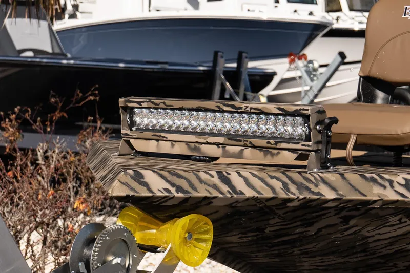 Slide: The Image of 2026 Excel 1860 Shallow Water F4 CC boat with camo design and LED light bar. - 4