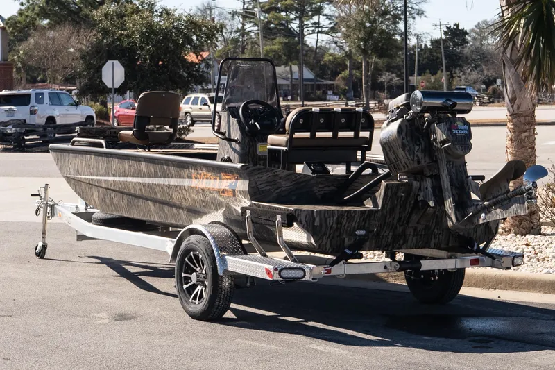 Slide: The Image of 2026 Excel 1860 Shallow Water F4 CC boat on trailer, parked outdoors. - 6