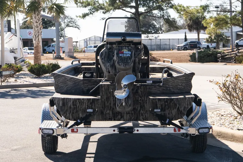 Slide: The Image of 2026 Excel 1860 Shallow Water F4 CC boat on trailer, outdoor setting. - 7