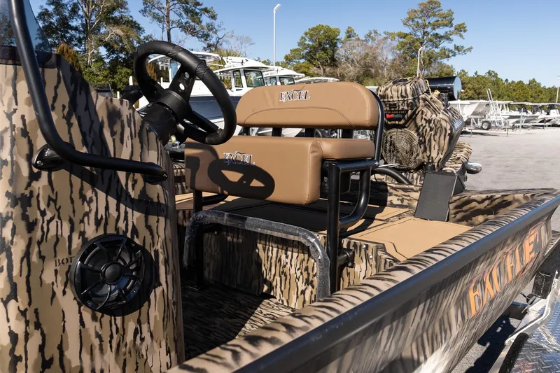 Slide: The Image of 2026 Excel 1860 Shallow Water F4 CC boat with camo design and tan seating. - 9