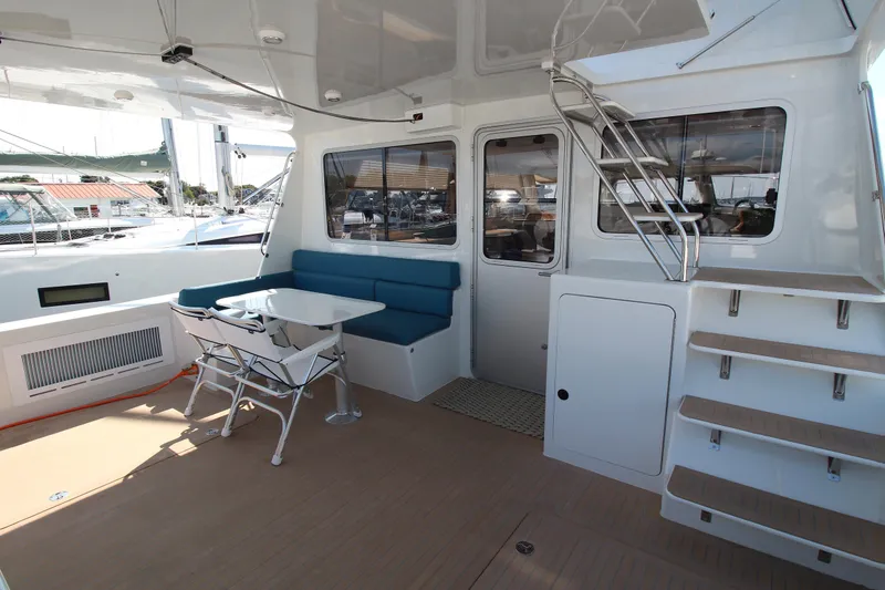 Slide: The Image of Modern yacht interior with seating area, table, and stairs on a 2026 Chris White Spindrift 47. - 1