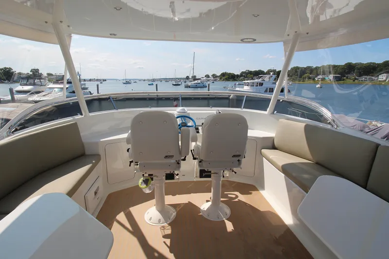Slide: The Image of Helm of 2026 Chris White Spindrift 47 yacht with scenic marina view. - 12