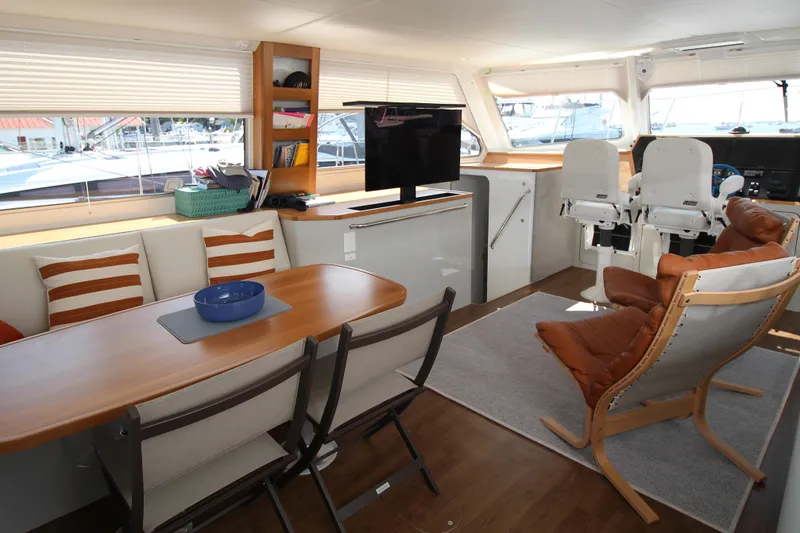 Slide: The Image of Luxurious interior of 2026 Chris White Spindrift 47 yacht with modern seating and dining area. - 2