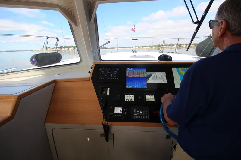 Slide: The Image of Helm of Chris White Spindrift 47 yacht, 2026 model, with navigation displays. - 4