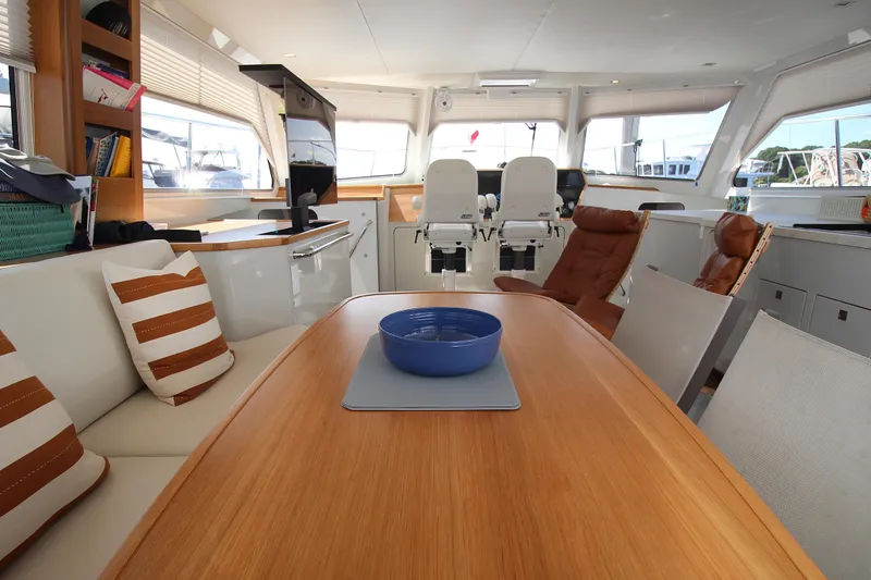 Slide: The Image of Luxurious interior of 2026 Chris White Spindrift 47 yacht with modern seating and dining area. - 6