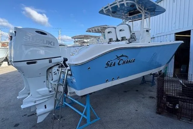 The Image of 2024 Sea Chaser 27 HFC CC boat with Suzuki outboard motor, displayed outdoors. - 1