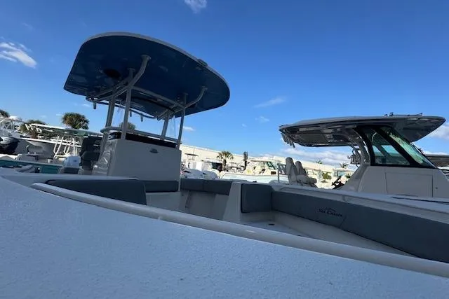 Slide: The Image of 2024 Sea Chaser 27 HFC CC boat under clear blue sky at marina. - 10