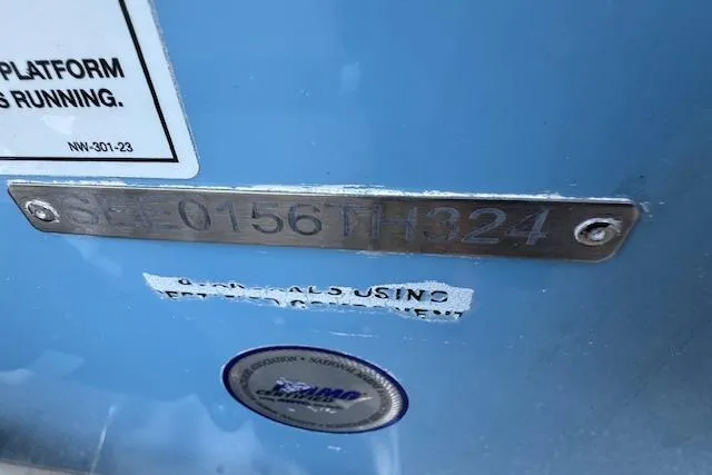 Slide: The Image of 2024 Sea Chaser 27 HFC CC boat identification plate on blue hull. - 2