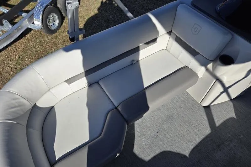 Slide: The Image of 2023 Godfrey Xperience 2286 SBX Sport Tube interior seating with gray upholstery and cup holder. - 1