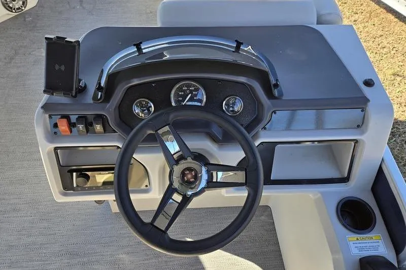 Slide: The Image of 2023 Godfrey Xperience 2286 SBX Sport Tube dashboard with steering wheel and controls. - 11