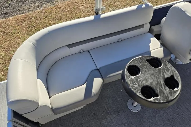 Slide: The Image of 2023 Godfrey Xperience 2286 SBX Sport Tube interior with gray seating and cup holder table. - 6