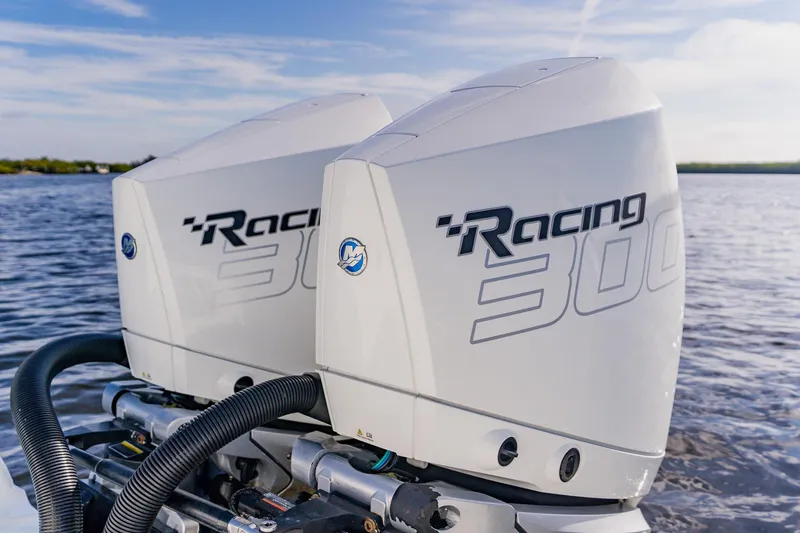 Slide: The Image of Twin Mercury Racing 300 outboard engines on 2024 Costa Custom Boats 34SV, cruising on open water. - 10