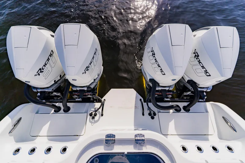 Slide: The Image of 2024 Costa Custom Boats 34SV with four powerful outboard engines on water. - 11