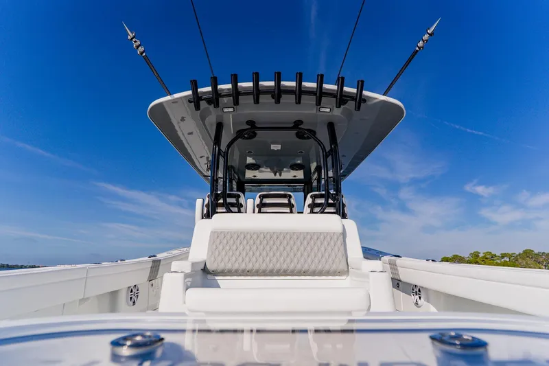 Slide: The Image of 2024 Costa Custom Boats 34SV, sleek design under clear blue sky. - 13