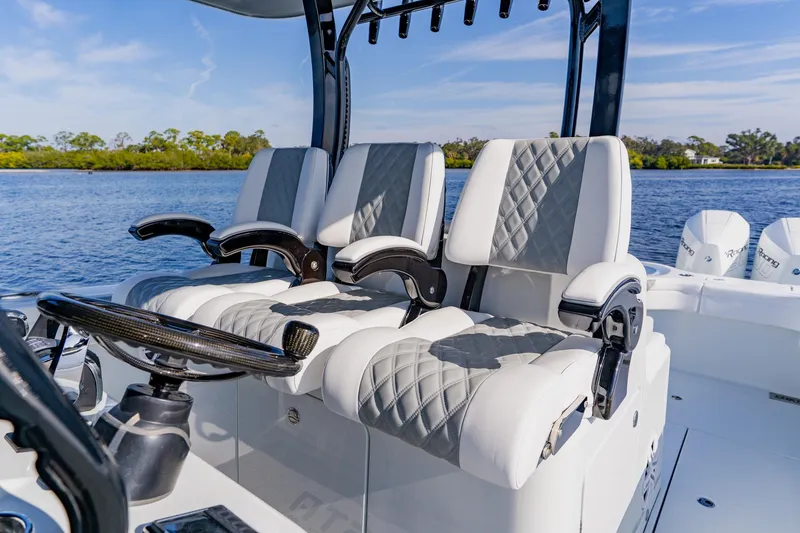 Slide: The Image of 2024 Costa Custom Boats 34SV cockpit with luxurious seating and scenic water view. - 18