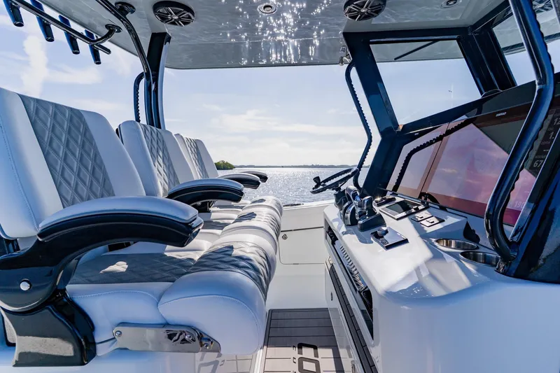 Slide: The Image of 2024 Costa Custom Boats 34SV cockpit with luxurious seating and advanced navigation controls. - 19
