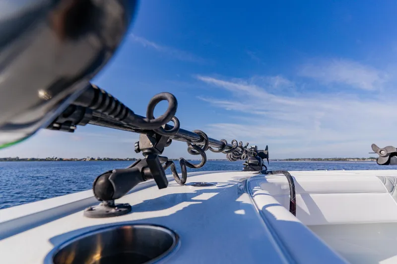 Slide: The Image of 2024 Costa Custom Boats 34SV fishing rod holders on deck, ocean view, clear blue sky. - 27