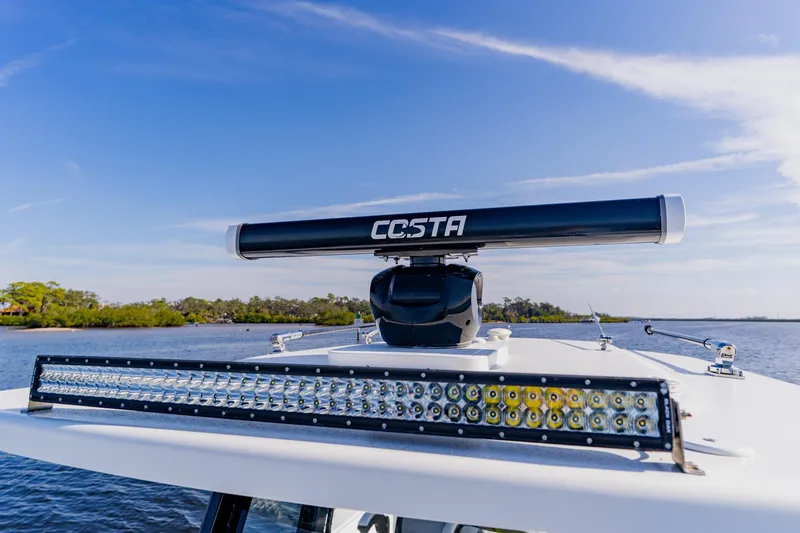 Slide: The Image of 2024 Costa Custom Boats 34SV radar and light bar on calm water. - 32