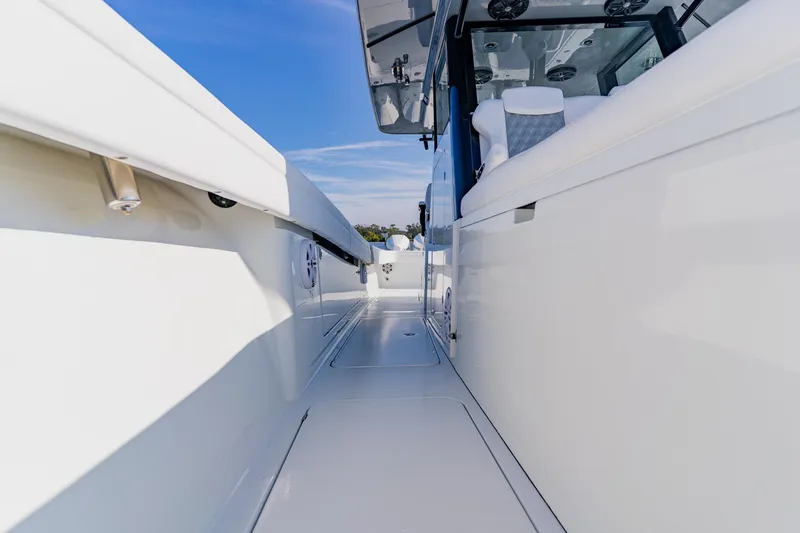 Slide: The Image of 2024 Costa Custom Boats 34SV, sleek white deck view under clear blue sky. - 34