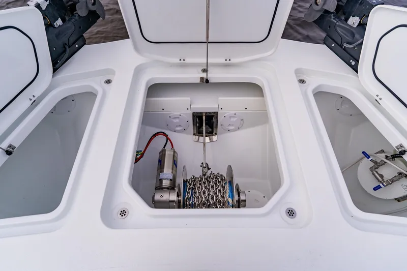 Slide: The Image of Anchor storage compartment on a 2024 Costa Custom Boats 34SV, featuring a winch and chain. - 39