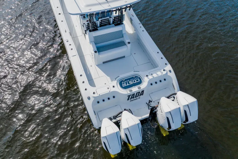 Slide: The Image of 2024 Costa Custom Boats 34SV with triple engines on water. - 4