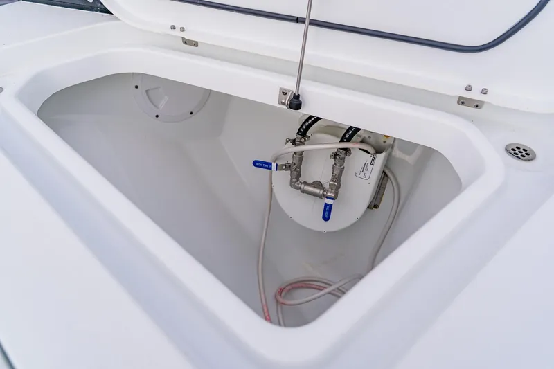 Slide: The Image of 2024 Costa Custom Boats 34SV storage compartment with plumbing components. - 40