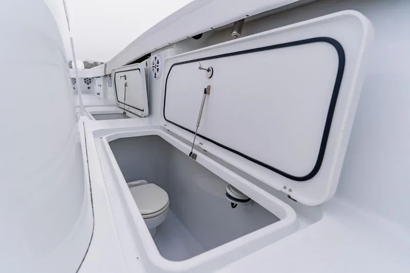 Slide: The Image of 2024 Costa Custom Boats 34SV interior storage compartments with open hatches. - 43