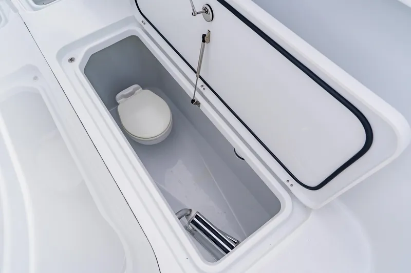 Slide: The Image of 2024 Costa Custom Boats 34SV interior storage compartment with a built-in toilet. - 44