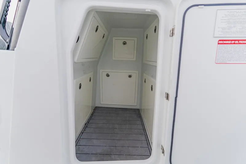 Slide: The Image of 2024 Costa Custom Boats 34SV interior storage compartment with multiple access panels. - 47