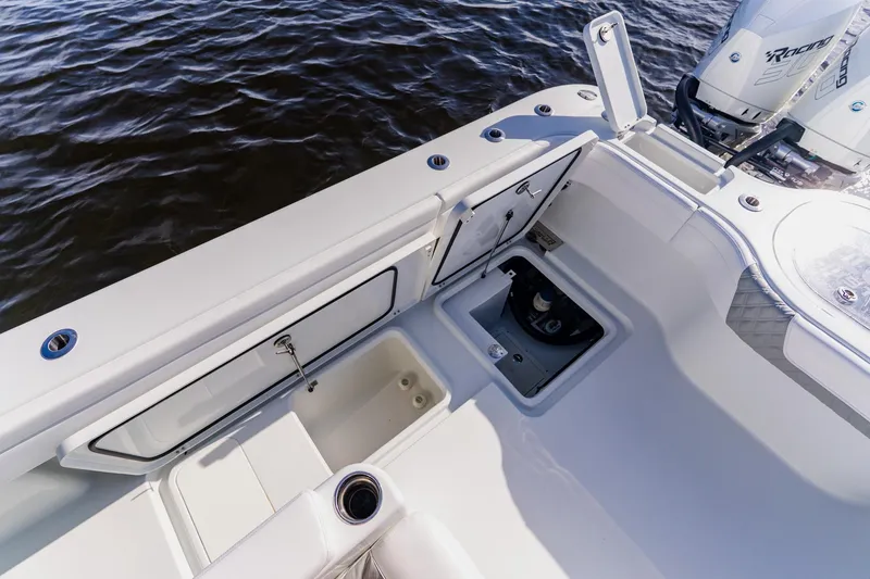 Slide: The Image of 2024 Costa Custom Boats 34SV deck view with storage compartments and engine details. - 51