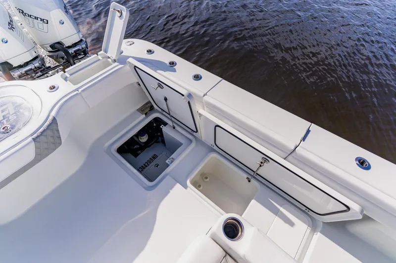 Slide: The Image of 2024 Costa Custom Boats 34SV, open storage compartments, sleek design, on calm water. - 52