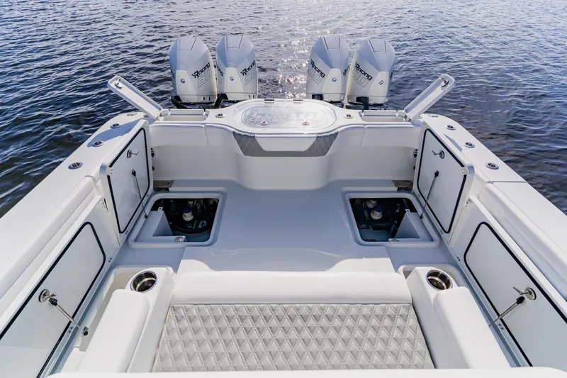 Slide: The Image of 2024 Costa Custom Boats 34SV, spacious deck with triple outboard engines on water. - 53