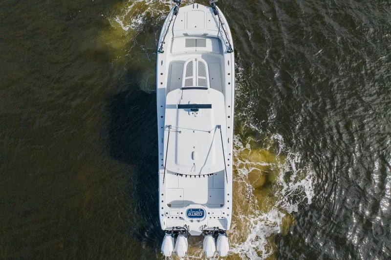 Slide: The Image of Overhead view of 2024 Costa Custom Boats 34SV navigating through water. - 6