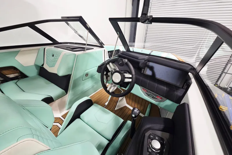 Slide: The Image of 2024 Nautique Super Air Nautique G23 interior with mint green upholstery and modern dashboard. - 10