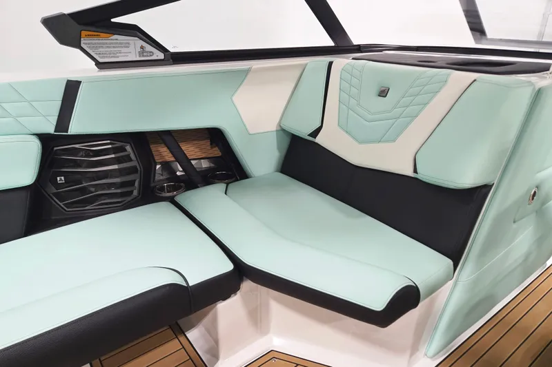 Slide: The Image of 2024 Nautique Super Air Nautique G23 interior with mint green and black seating. - 13