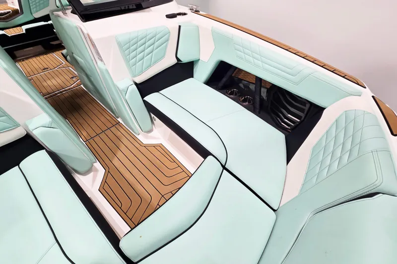 Slide: The Image of 2024 Nautique Super Air Nautique G23 interior with mint green upholstery and teak flooring. - 15