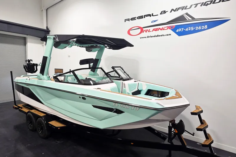 Slide: The Image of 2024 Nautique Super Air Nautique G23 boat in showroom, mint green and white design. - 3