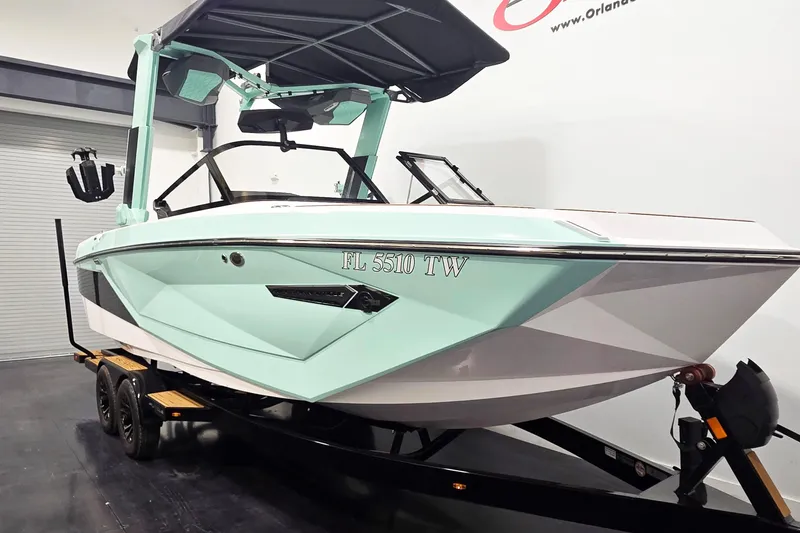 Slide: The Image of 2024 Nautique Super Air Nautique G23 boat on trailer, mint green and white design. - 4