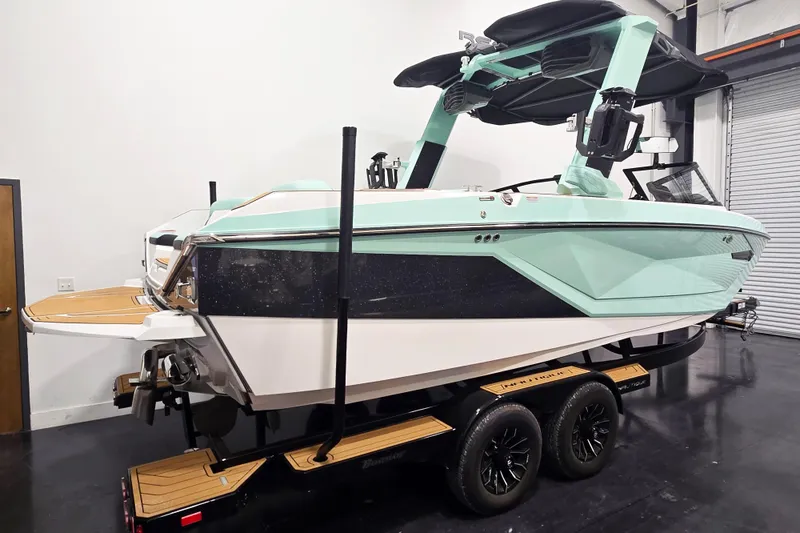 Slide: The Image of 2024 Nautique Super Air Nautique G23 boat in showroom, mint green and black design. - 5
