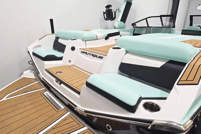 Slide: The Image of 2024 Nautique Super Air Nautique G23 boat with mint and black seating, teak flooring. - 7