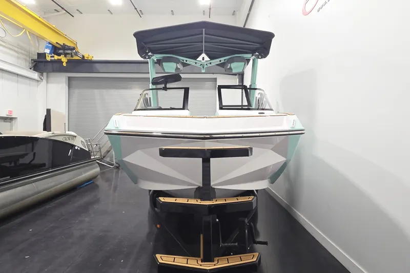 Slide: The Image of 2024 Nautique Super Air Nautique G23 boat in showroom, rear view. - 8