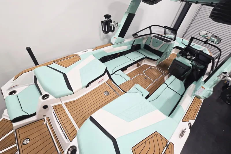 Slide: The Image of 2024 Nautique Super Air Nautique G23 interior with mint and wood accents, luxury seating. - 9