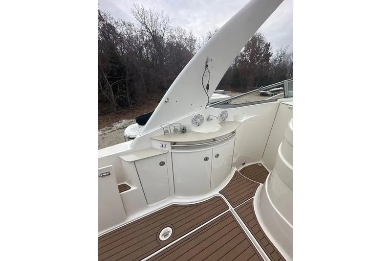 Slide: The Image of 2004 Chaparral Signature 350 yacht interior with sleek white cabinetry and wood flooring. - 4