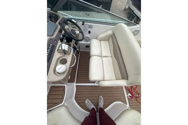 Slide: The Image of 2004 Chaparral Signature 350 boat interior with helm, seating, and wooden flooring. - 5